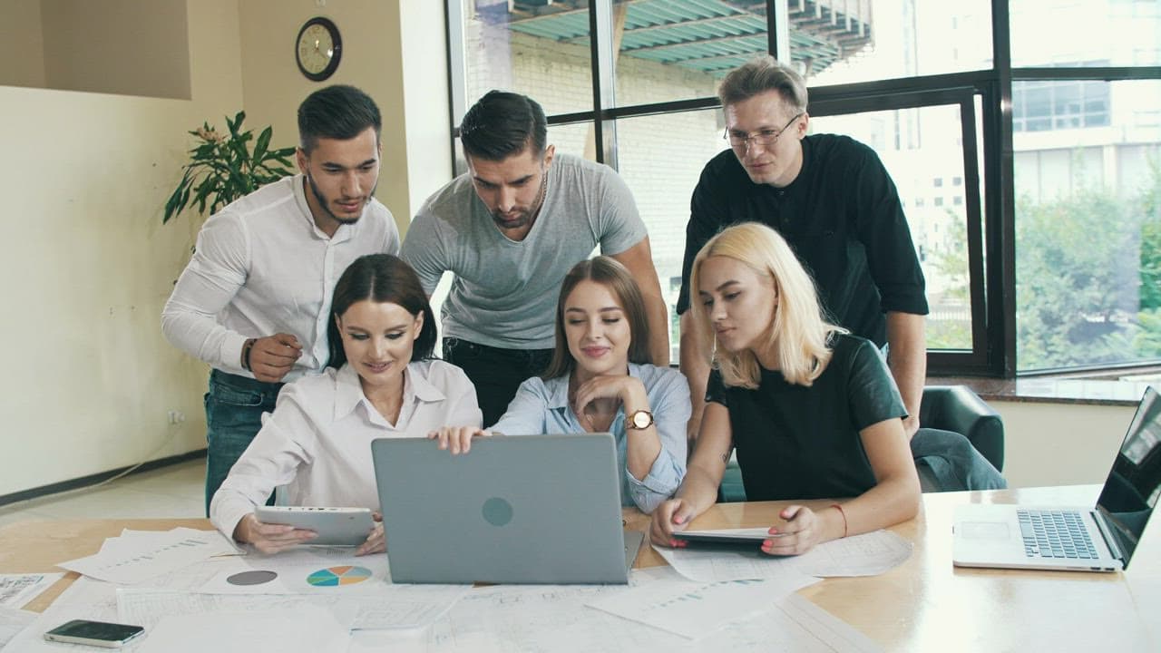 Fortgate Technologies team collaborating around a laptop