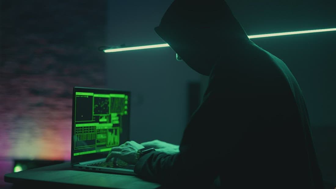 Security specialist testing a system for vulnerabilities on a laptop