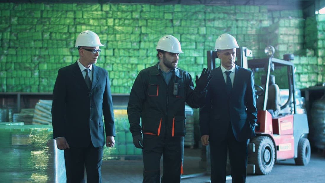 Managers inspecting warehouse operations supported by an ERP system