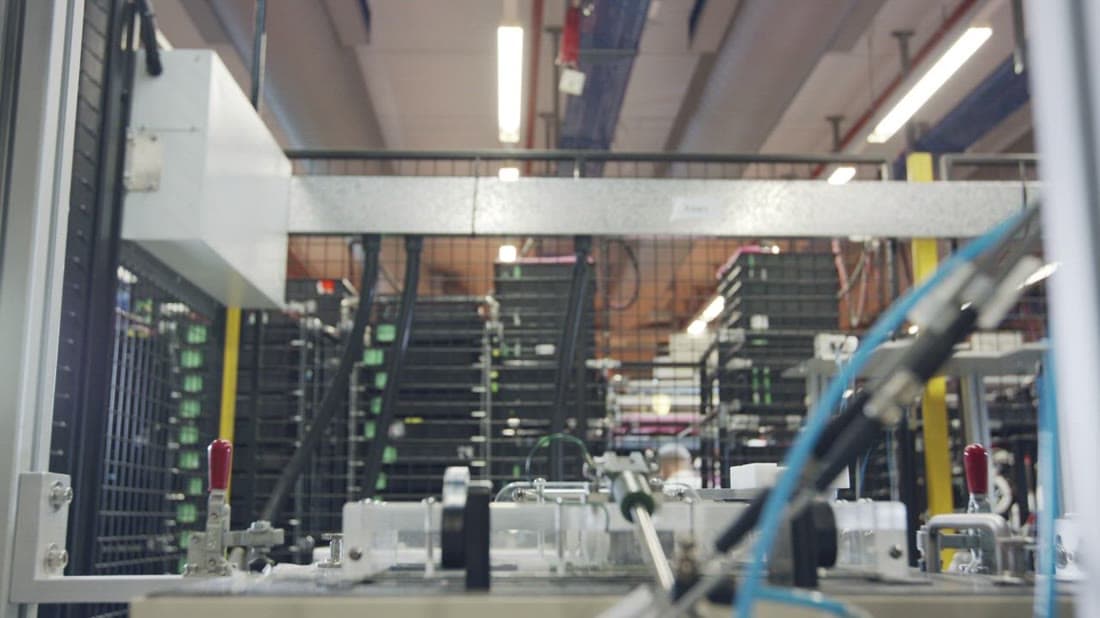 Automated robotic production line in an electronics manufacturing facility