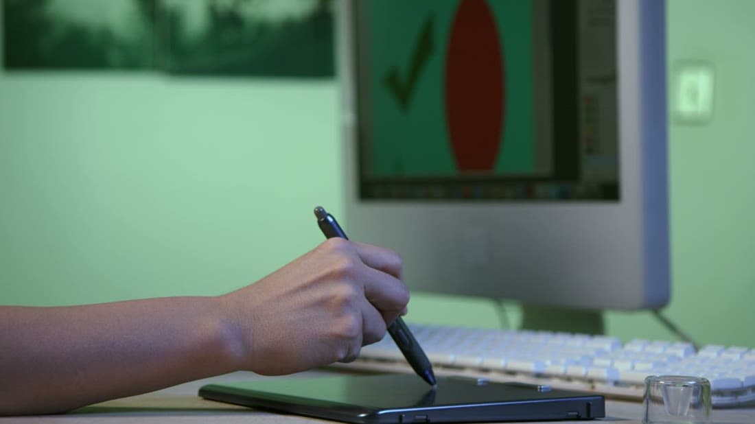 Graphic designer creating a logo on a digital drawing tablet