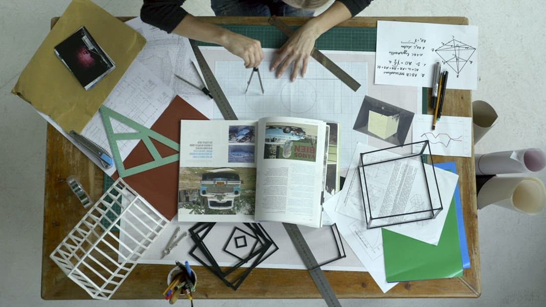 Designer sketching brand concepts and moodboards on a desk