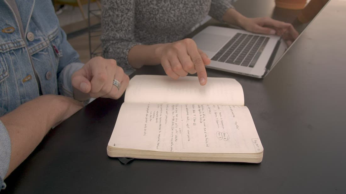 Account managers planning a customer meeting with laptops and notes