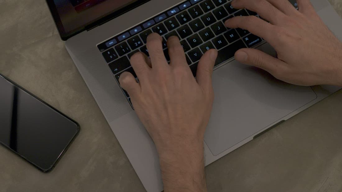 Tester running software tests on a laptop